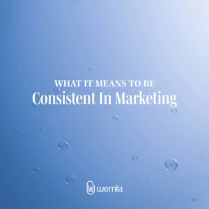 Soap bubbles on blue sky and text What it means to be consistent in marketing