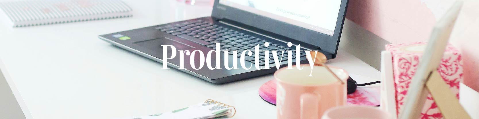 Desk with laptop ststionery and text Productivity